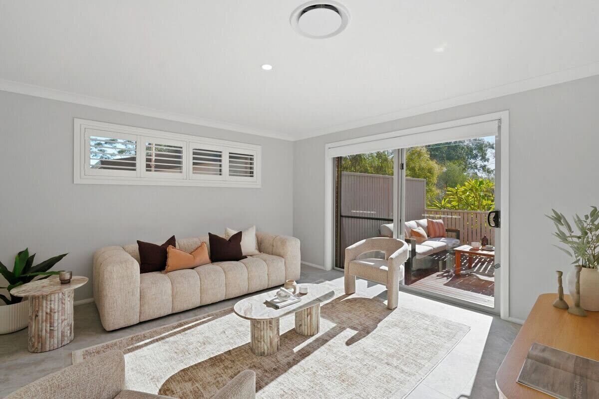 Living room opening to the alfresco balcony lounge