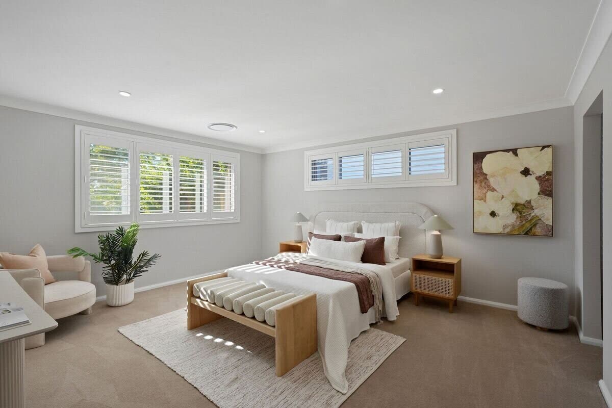 Master bedroom with cane bedside tables and plantation shutters